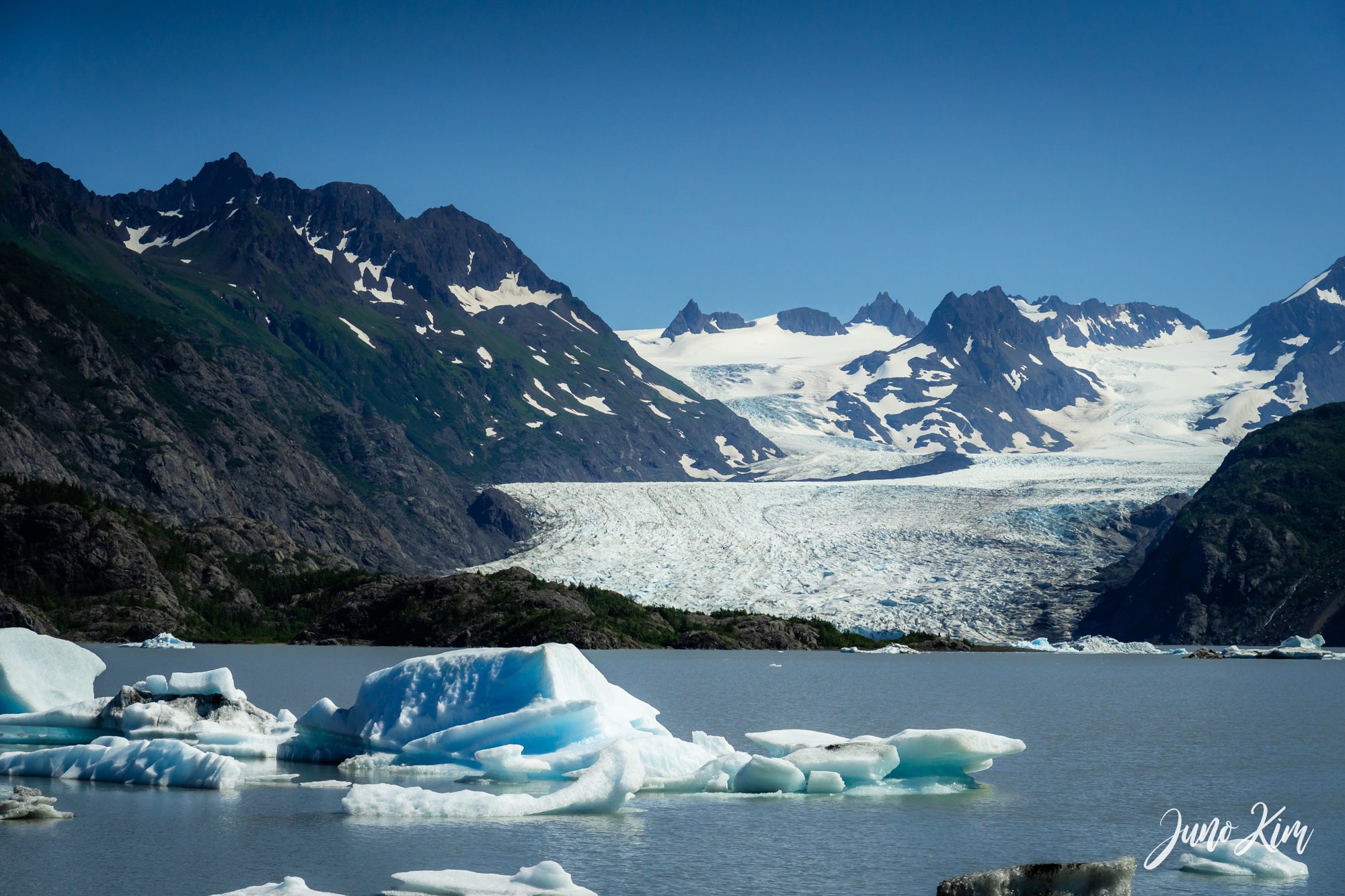 Grewingk Glacier Lake with mountain peaks reflected in the water