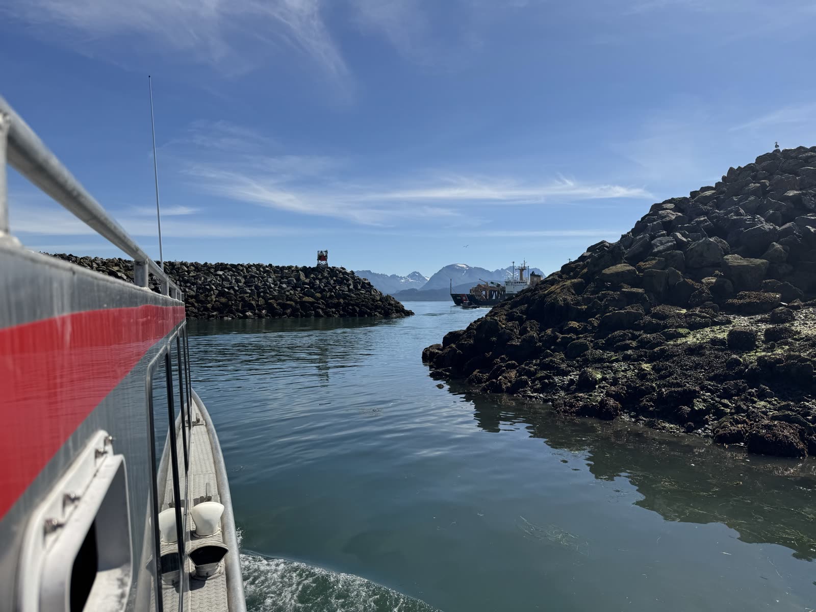Departing Homer Harbor for Kachemak Bay with distant snow-capped mountains